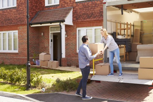 Professional movers packing fragile household items