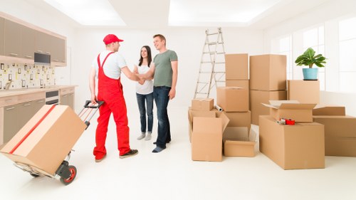 Professional movers navigating a narrow Notting Hill staircase with care