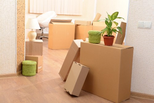 Local house movers in Nottinghill carrying boxes through a suburban home