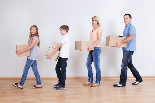 Moving team unloading boxes at a Nottinghill home with local access challenges